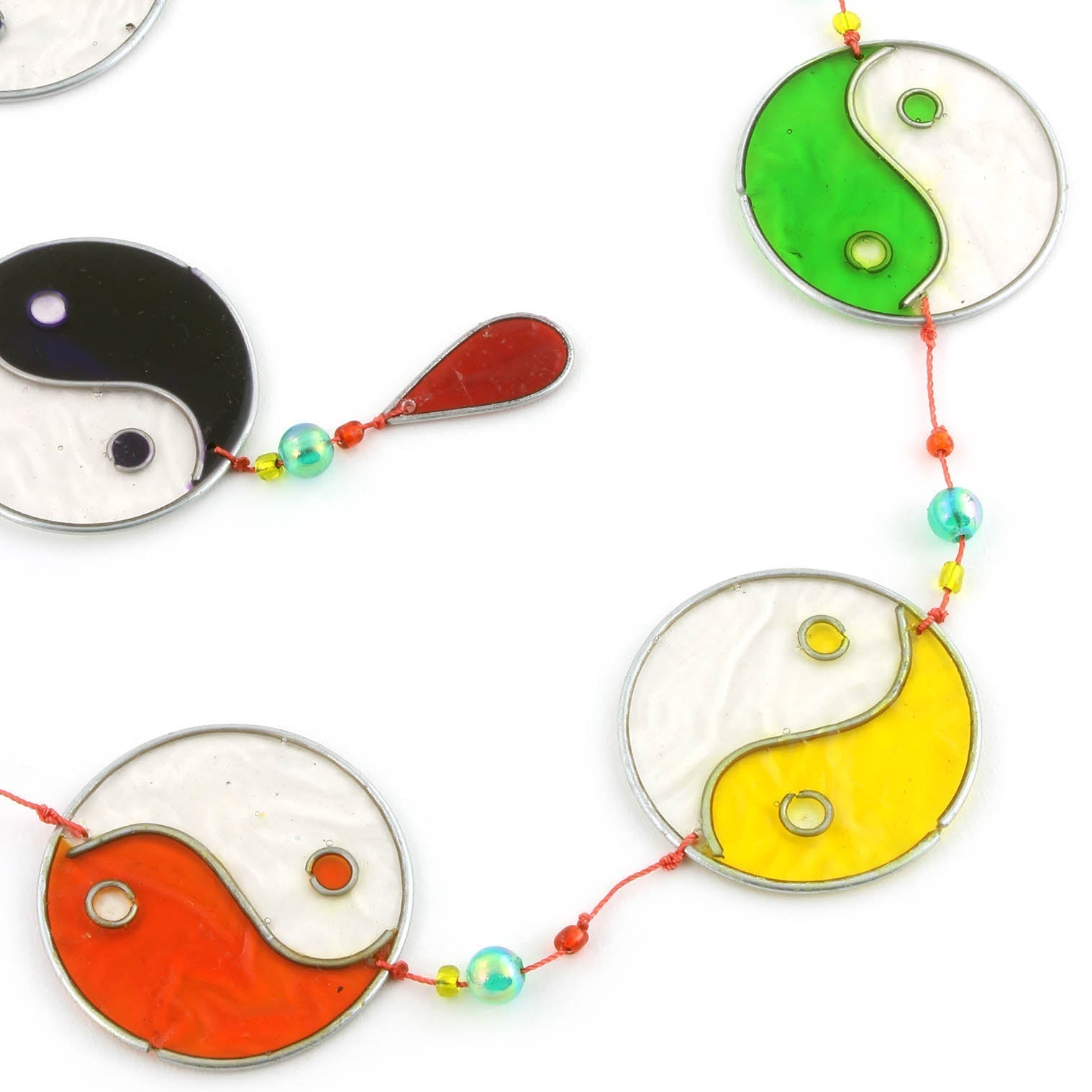 Vertical string of five yin yang suncatchers in contrasting colour pairings, with coloured beads strung between the discs