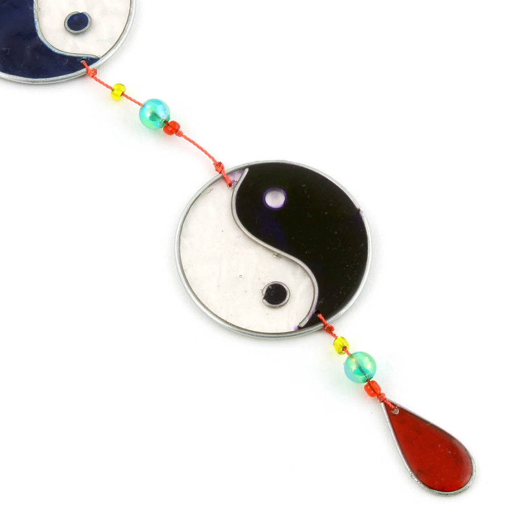 Vertical string of five yin yang suncatchers in contrasting colour pairings, with coloured beads strung between the discs
