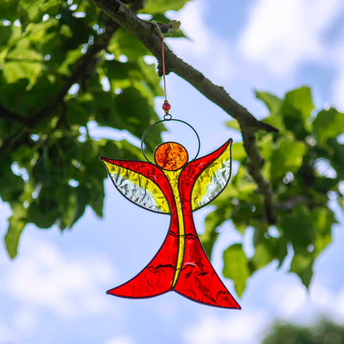 Angel-shaped suncatcher in warm red and amber resin with outstretched wings rising to a halo, in a soldered metal frame