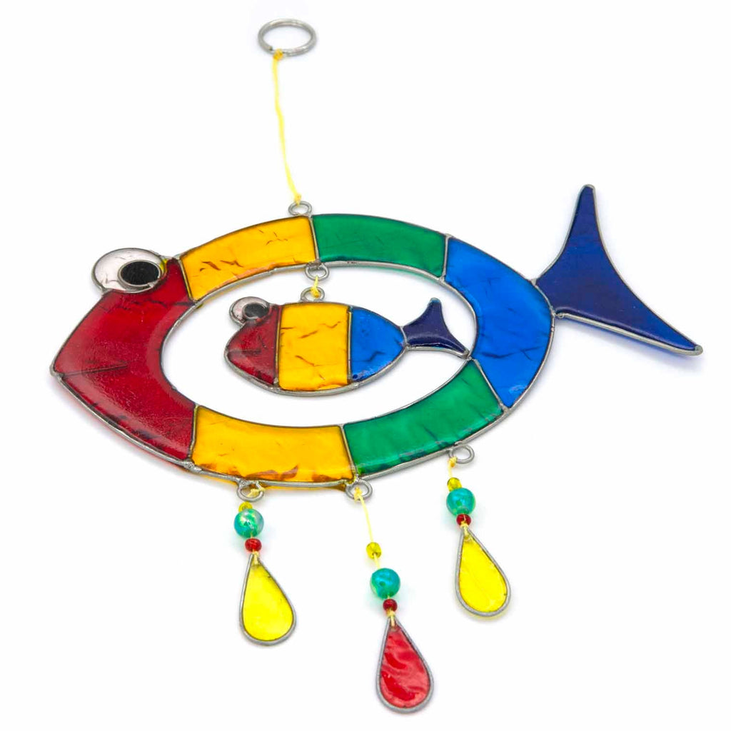 Suncatcher of two cheerful fish, a big one with a smaller fish inside, in bright primary colours with red, yellow and amber glass teardrops dangling beneath