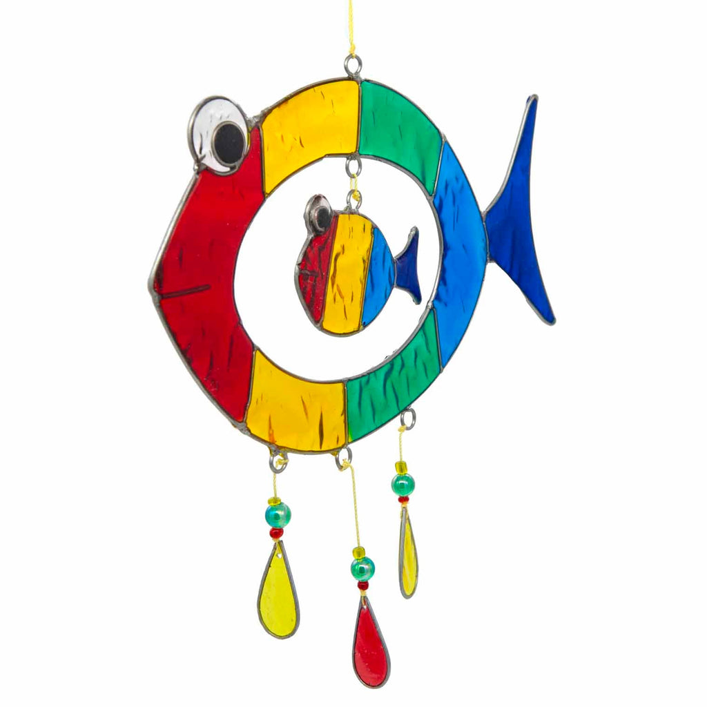Suncatcher of two cheerful fish, a big one with a smaller fish inside, in bright primary colours with red, yellow and amber glass teardrops dangling beneath