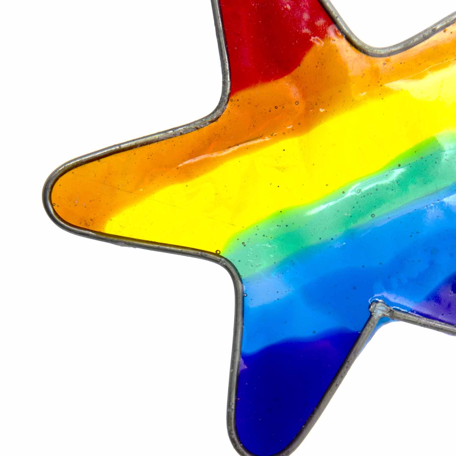 Small star-shaped suncatcher with a bright rainbow stripe running across it, in a soldered metal frame