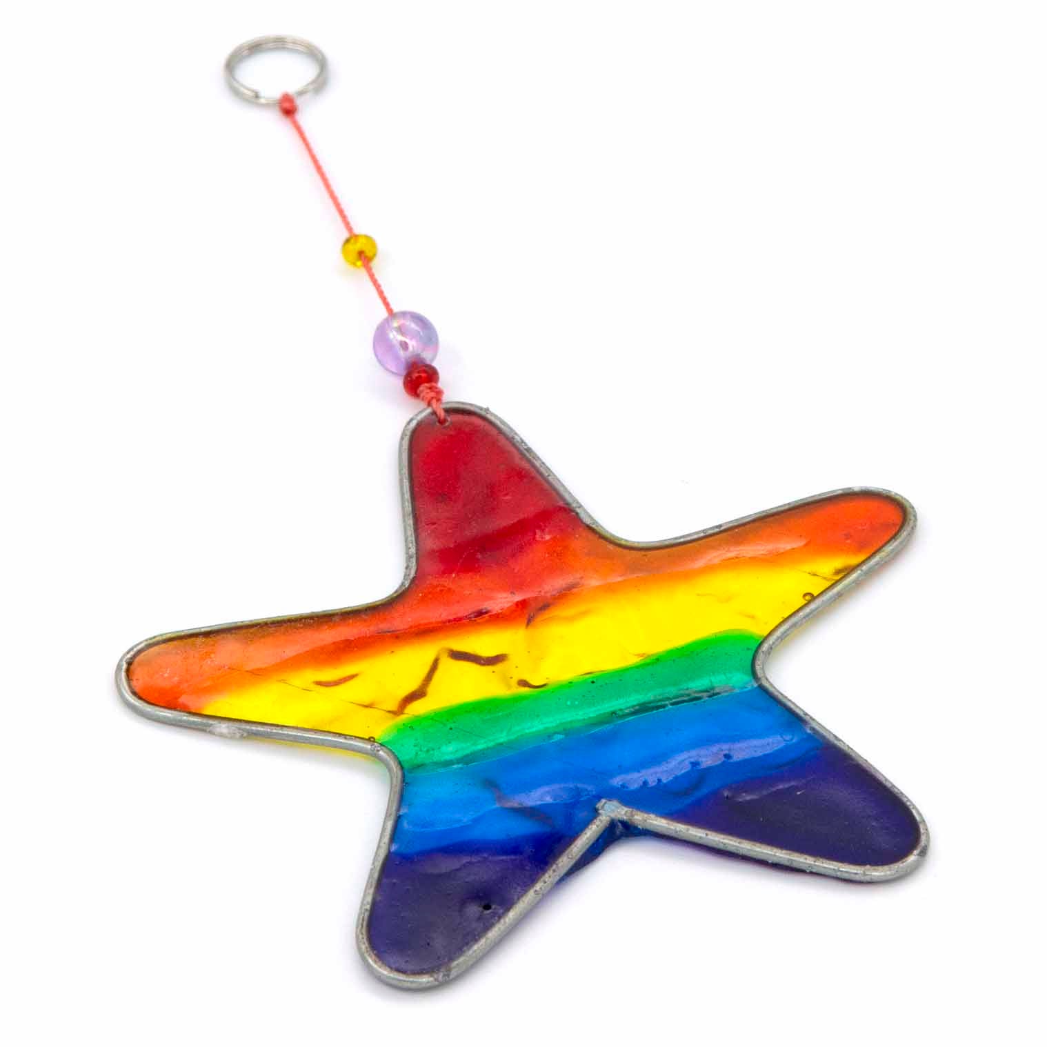 Small star-shaped suncatcher with a bright rainbow stripe running across it, in a soldered metal frame