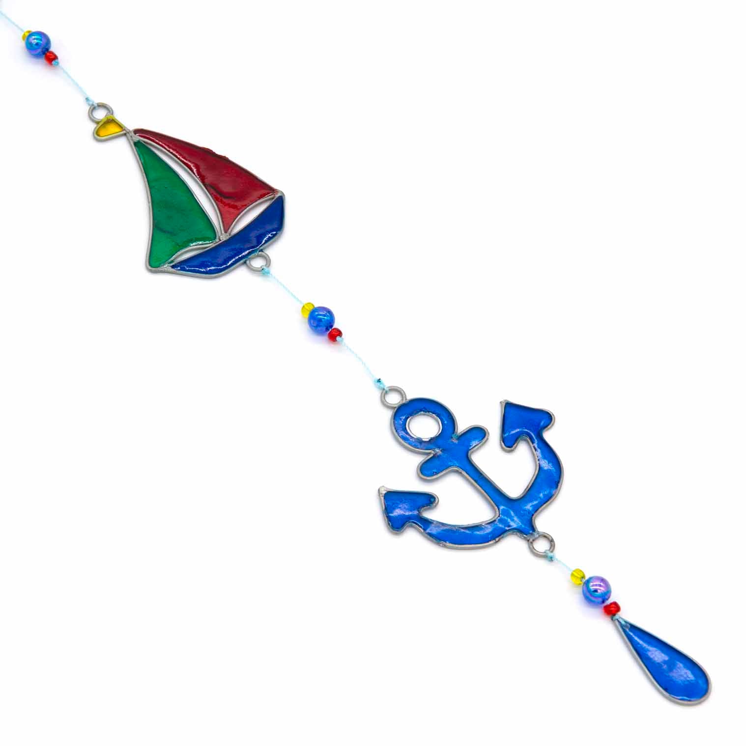 Nautical hanging suncatcher with a blue seahorse, a deep blue anchor and a red striped lighthouse strung vertically in soldered metal frames