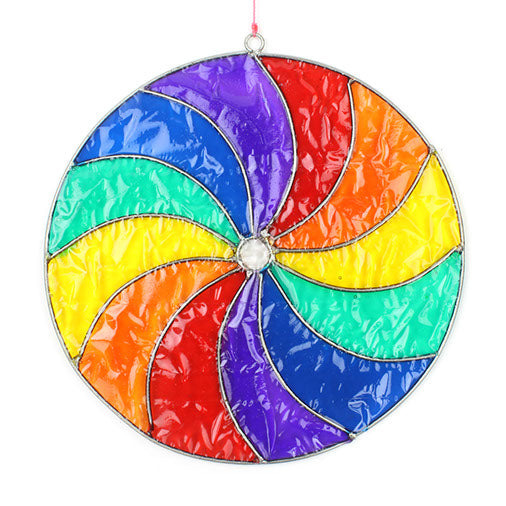 Round suncatcher with bold rainbow segments curving from the centre in a spinning pinwheel pattern, in a soldered metal frame