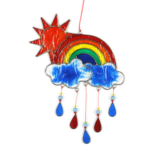 Stained-glass effect suncatcher of a red sun rising over a rainbow arc, with two clouds and dangling red, yellow and blue raindrop pendants