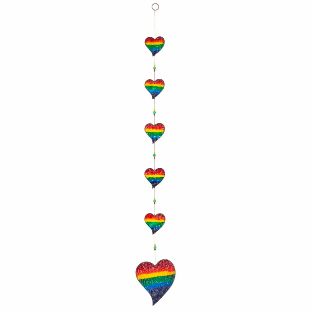Vertical string of six rainbow-striped heart suncatchers in stained-glass effect resin, each with a small arrow detail at the top
