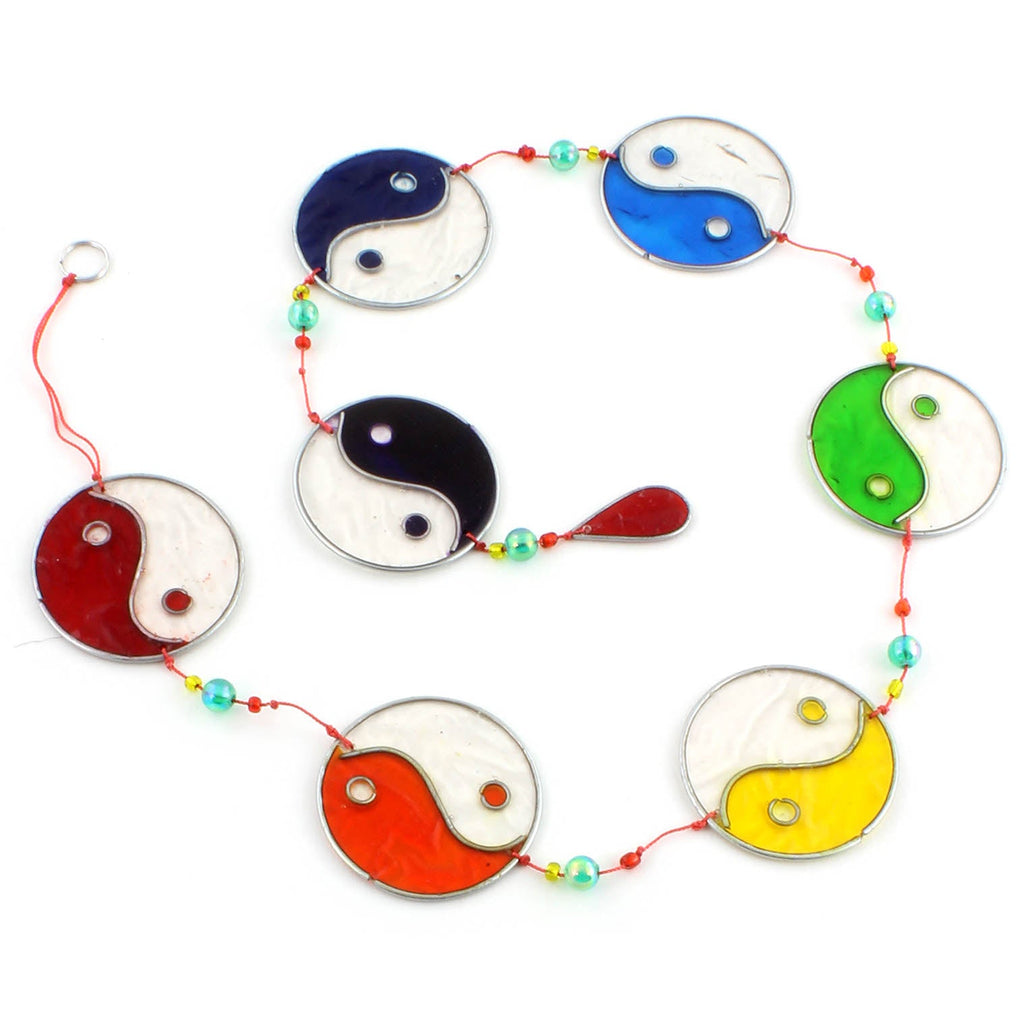 Vertical string of five yin yang suncatchers in contrasting colour pairings, with coloured beads strung between the discs