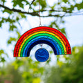 Classic rainbow arch suncatcher in red, orange, yellow, green, blue and purple with a deep blue circle at the base