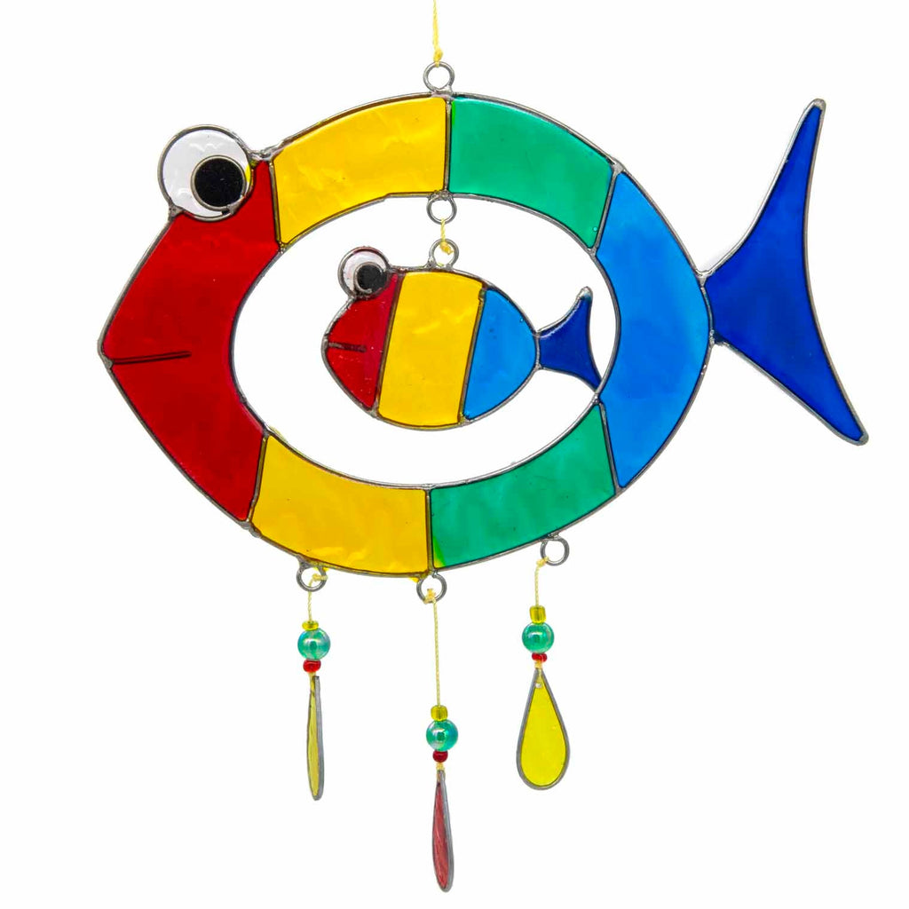 Suncatcher of two cheerful fish, a big one with a smaller fish inside, in bright primary colours with red, yellow and amber glass teardrops dangling beneath