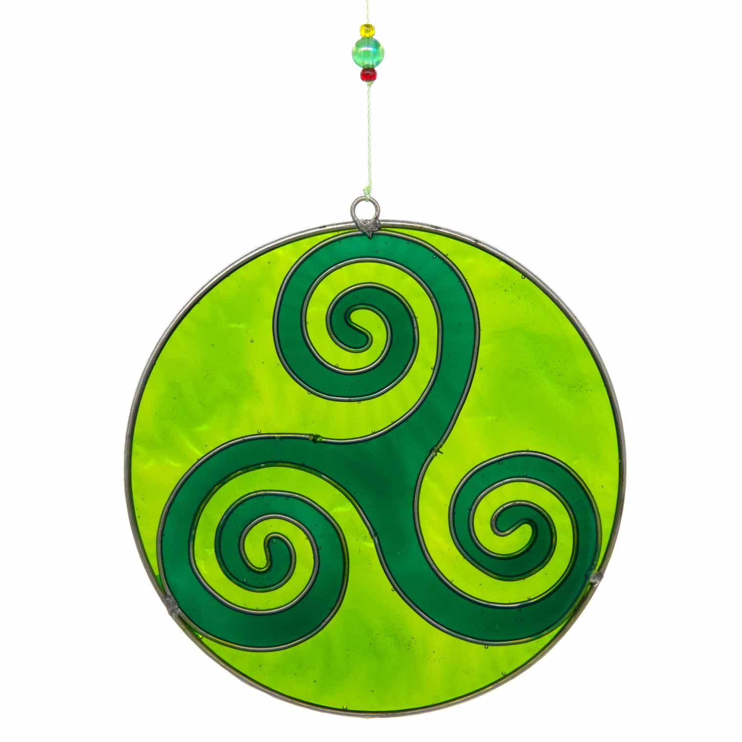 Round deep-green suncatcher with a Celtic triskele of three interlocking spirals, in a soldered metal frame