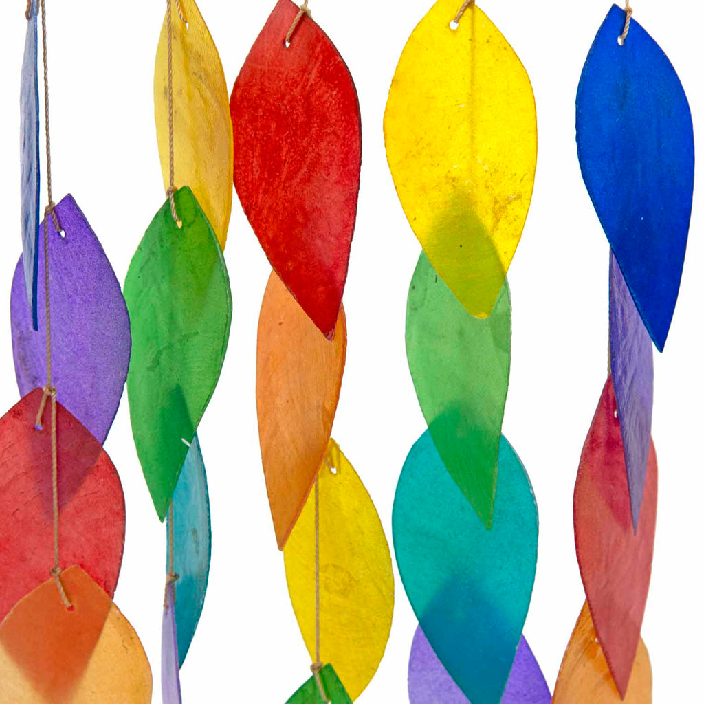 Hanging windchime of rainbow-coloured shell leaves strung from a length of bamboo
