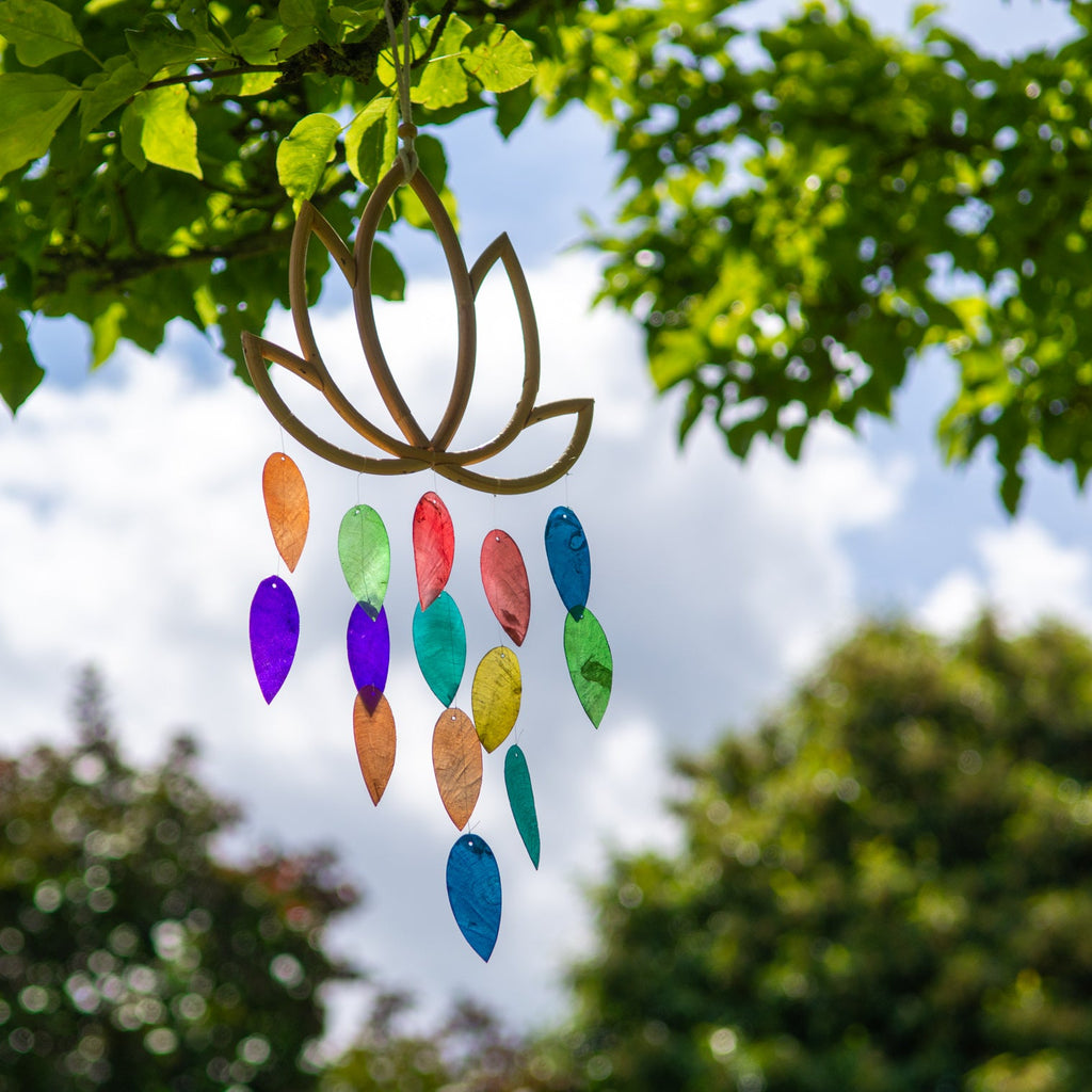 Hanging decoration with jewel-tone shell leaves dangling beneath a carved bamboo lotus flower