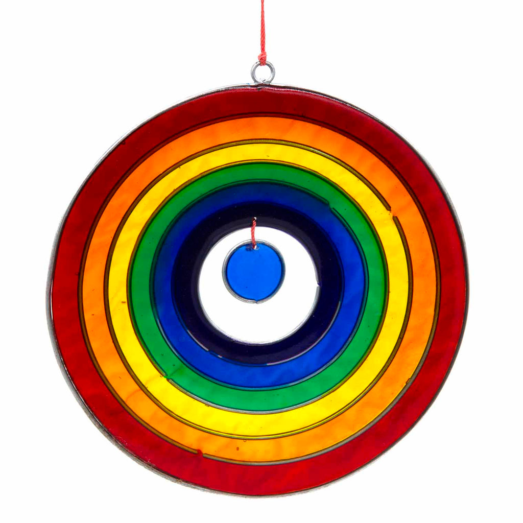 Round suncatcher with concentric rings of rainbow colour radiating from a deep blue centre, in a soldered metal frame