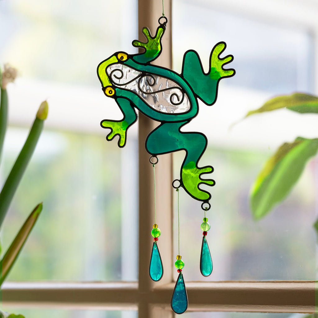 Cheerful green frog suncatcher in translucent panels with a painted face and dangling teardrop beads beneath