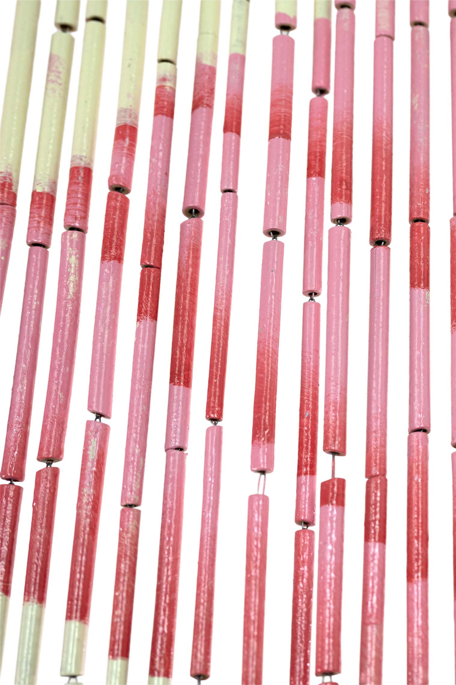 Hand-painted bamboo bead curtain with a bold pink flamingo design, hanging in a doorway