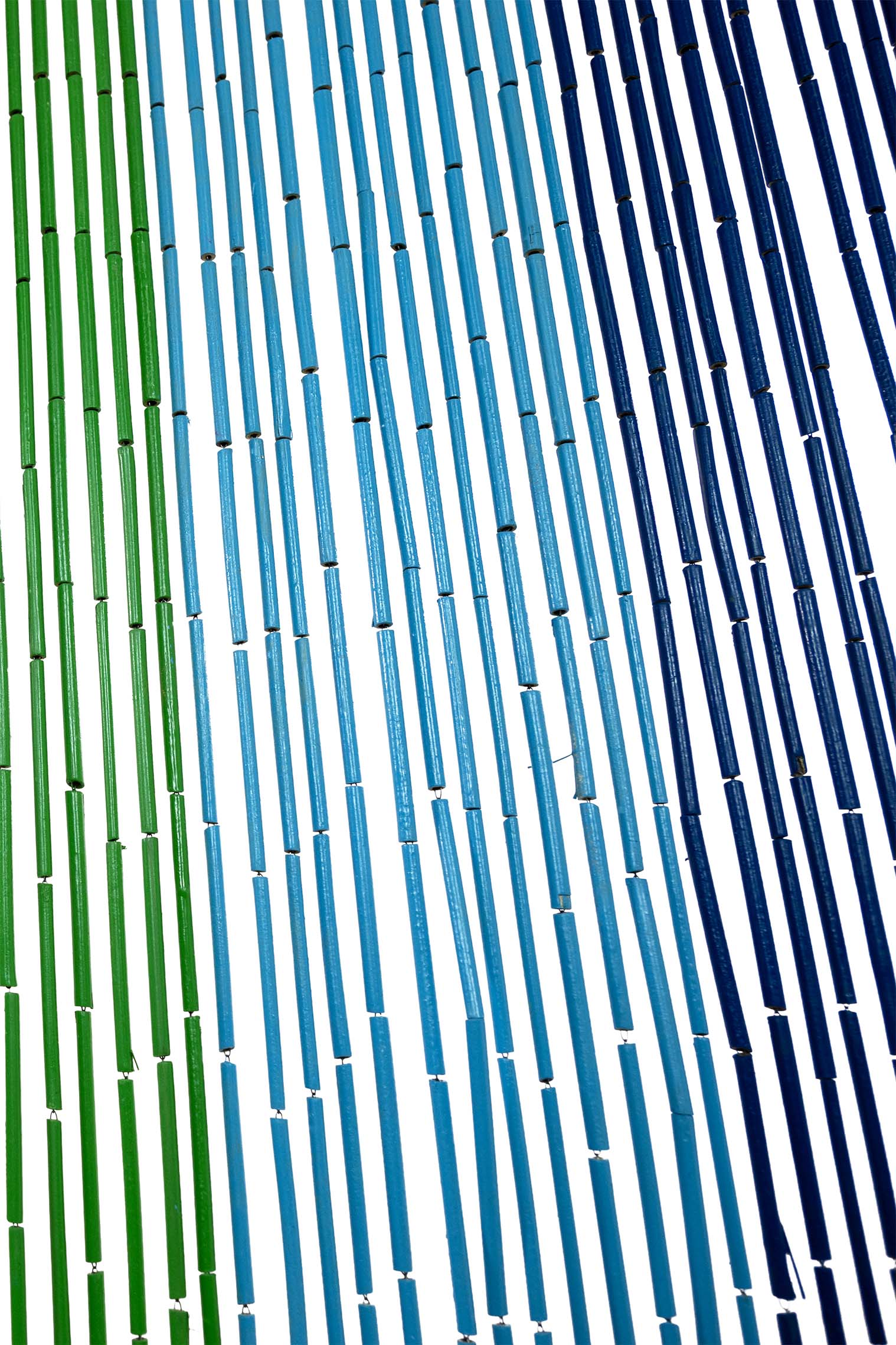 Hand-painted bamboo bead curtain with bright horizontal rainbow stripes, hanging in a doorway