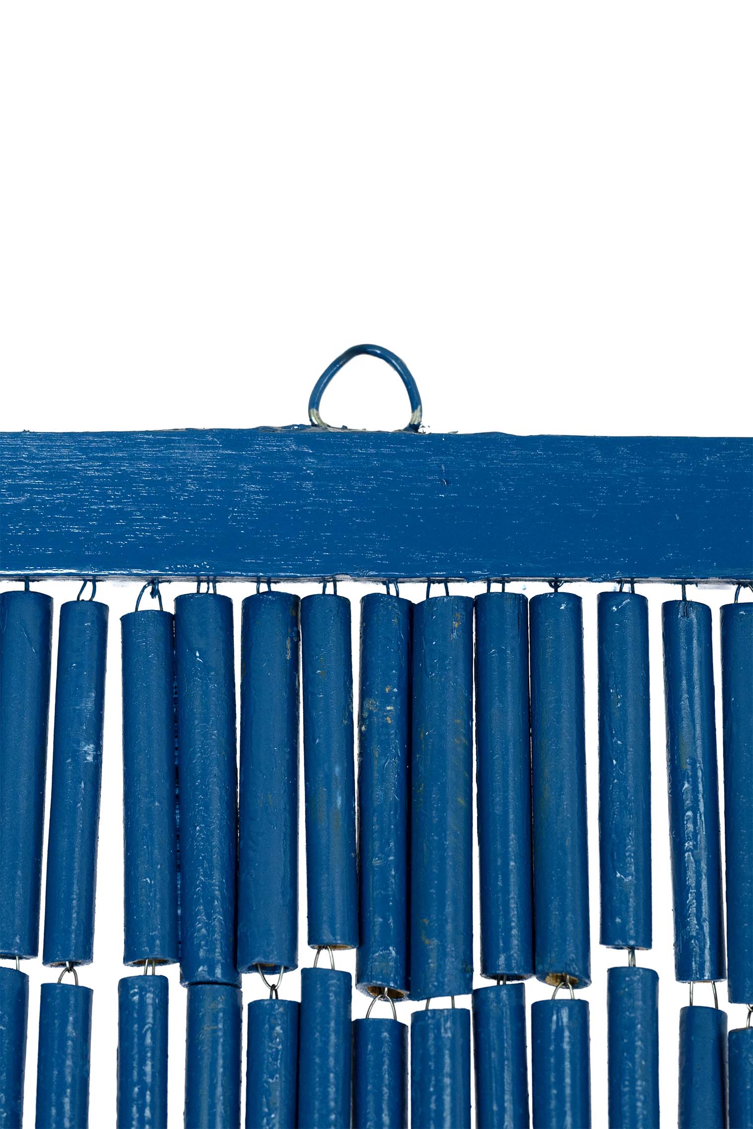 Hand-painted bamboo bead curtain showing a tropical sunset with palm tree silhouettes, hanging in a doorway